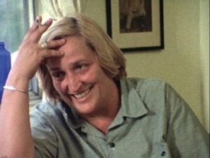 Photo of Pat Bond smiling with cigarette in hand
